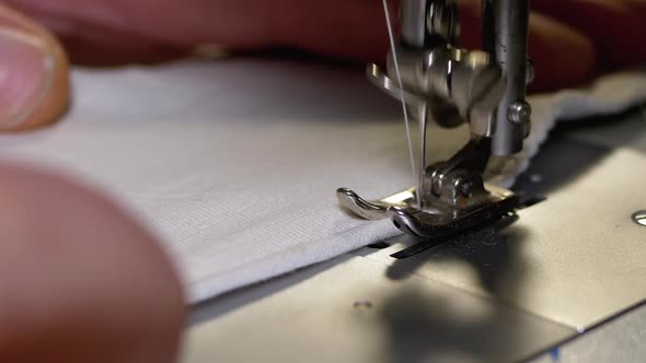 Tailor at Sewing Machine Sews a Homemade Medical Face Mask To Protect Covid-19