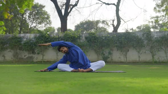 Yoga is being done by an Indian man in an Indian outfit Kurta Pajama