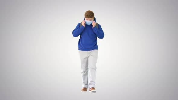 Schoolboy with Backpack Wearing Medical Mask Walking on Gradient Background