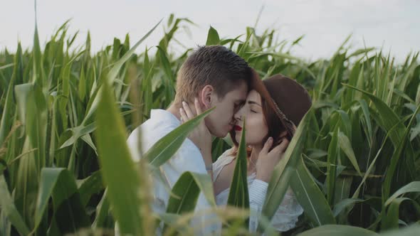 Young Hipster Men Hugging and Kissing in Front of Corn Field or Farmland Medium Shot