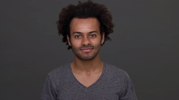 Young African American Boy Cheerly Nodding His Head and Showing Index Finger on Camera Isolated Over