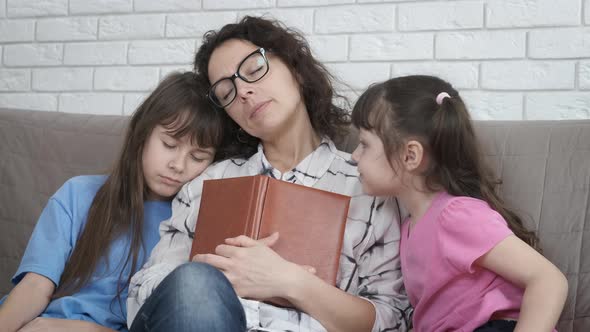 The woman fell asleep while reading a book. 