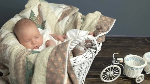 Sleeping Caucasian Baby in Basket.