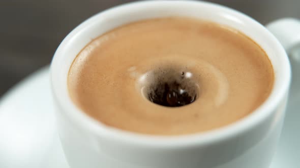 Drop Falling Into a Cup of Coffee in Super Slowmotion.