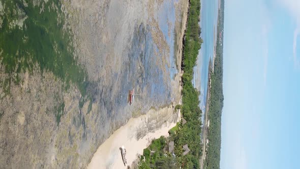 Vertical Video of Low Tide in the Ocean Near the Coast of Zanzibar Tanzania Aerial View