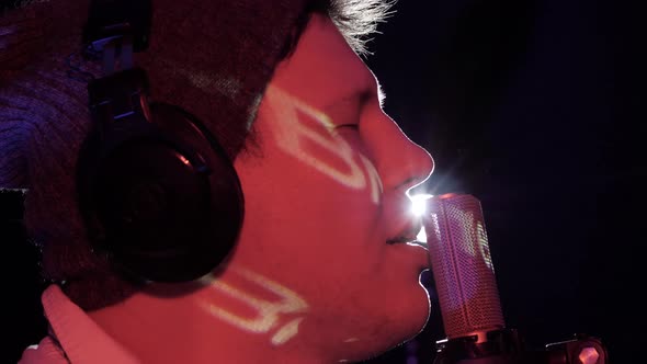 Close Up Face Man Singer Vocalist and Microphone on Music Concert in the Rays of Stage Light