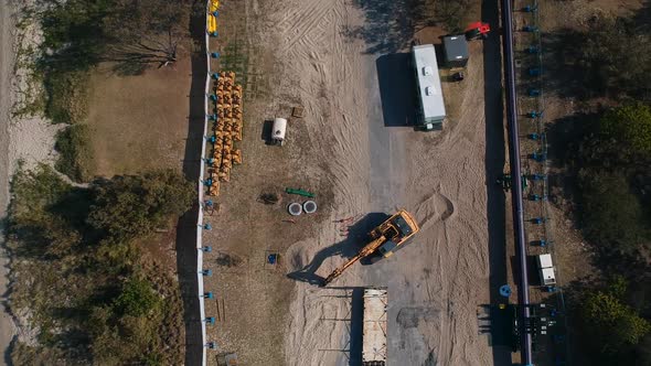 A construction site close to a major city undertaking infrastructure works on a coastal peninsular t