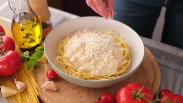 Making Pasta Carbonara  Pouring Grated Parmesan Cheese Spaghetti in Ceramic Dish