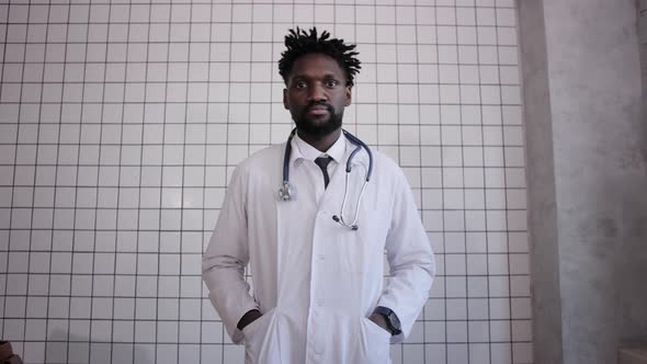 Closeup Portrait of Black Doctor Smiling and Looking at Camera