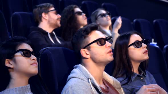 People Watch 3D Film at the Movie Theater 