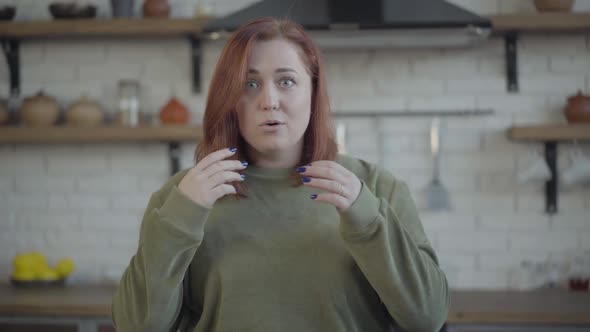 Middle Shot of Redhead Young Caucasian Woman with Excited Facial Expression Looking at Camera