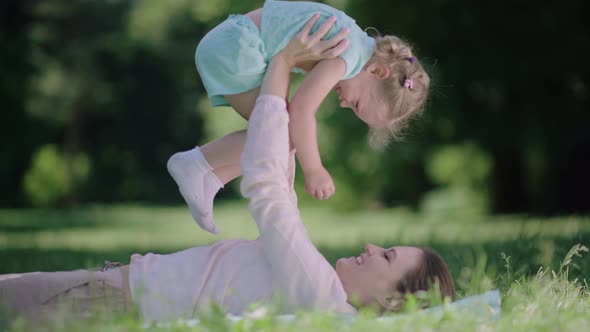 Family Fun. Mother And Daughter Playing And Laughing In Park