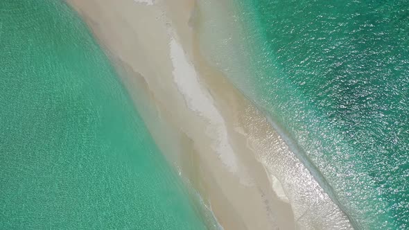 Tropical drone tourism shot of a white sand paradise beach and blue sea background 