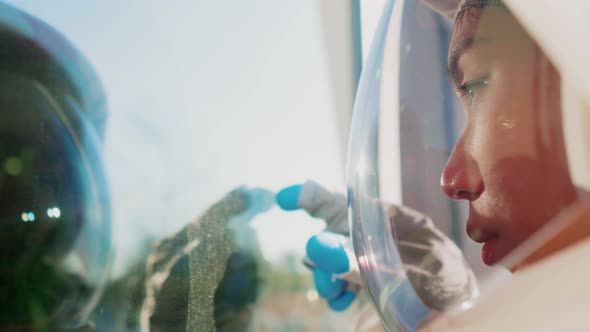 Close-up of spacewoman examining glass pane