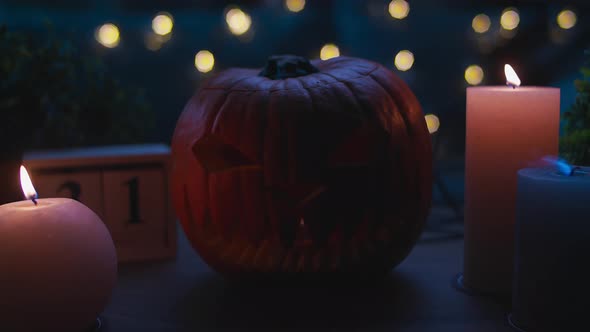 JackoLantern Pumpkin and Candles on Table with White Smoke