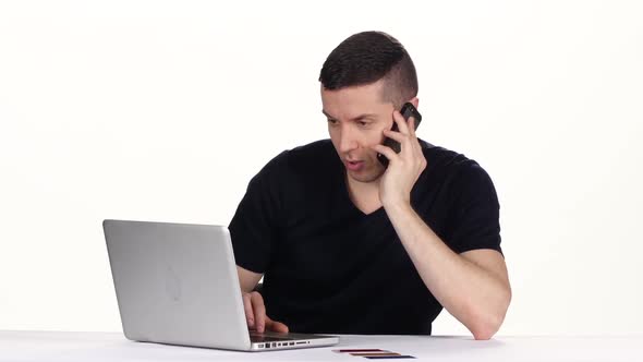 Man Tells on the Phone and Completes Online Shopping. White