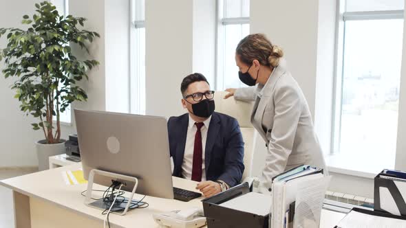 Business Colleagues in Face Masks Discussing Work
