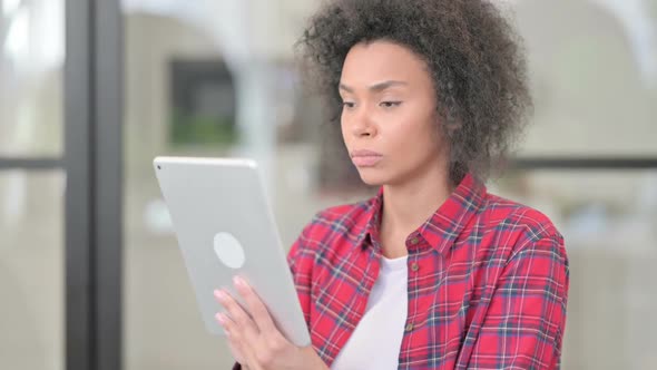 African Woman Using Tablet Browsing Internet