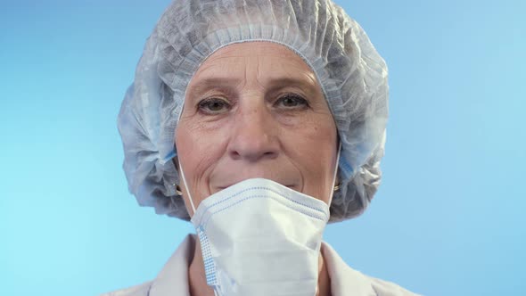 Physician Takes Off a Surgical Mask and Smiling