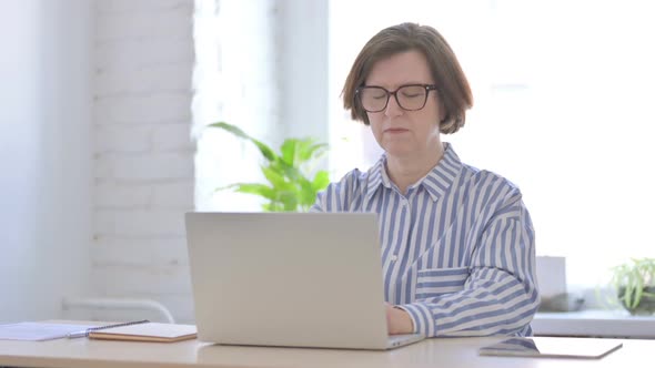 Senior Woman Having Toothache at Work