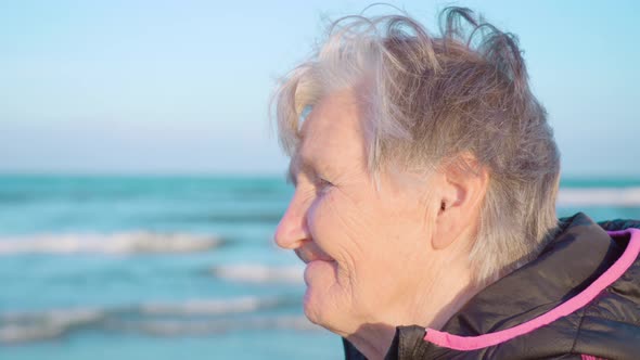 Senior Woman Smiles Enjoying Azure Sea View at Chioggia