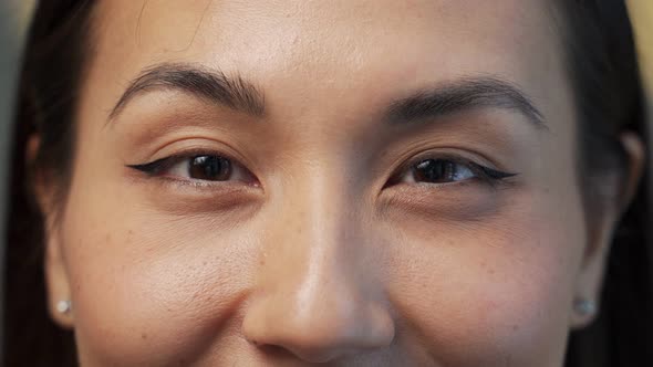 Close Up of Beautiful Young Asian Woman with Brown Eyes