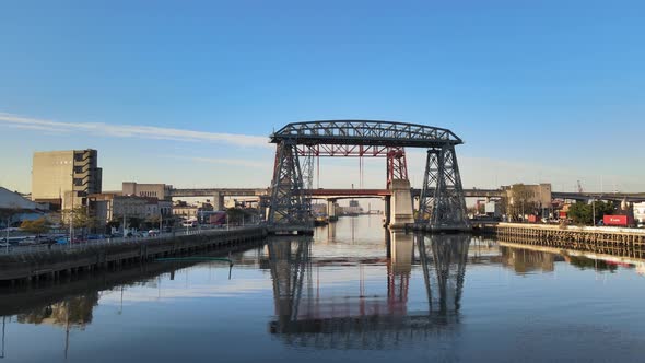 Wide pan of Puente Transbordador and red bridge behind it, Buenos Aires