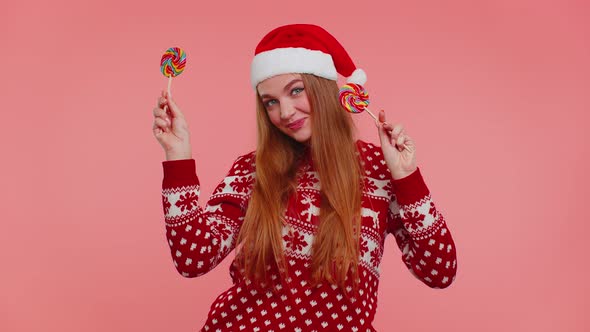 Funny Girl in New Year Sweater Holding Candy Striped Lollipops Hiding Behind Them Fooling Around