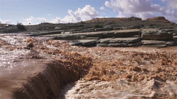 Muddy River Rapids in Sunny Day after Heavy Rain Shower