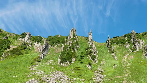 Timelaps Shot with Fast Moving Clouds in a Beautiful Green Valley of the Mountains in Summer