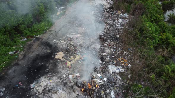 Aerial fly away open burning at rubbish dump site