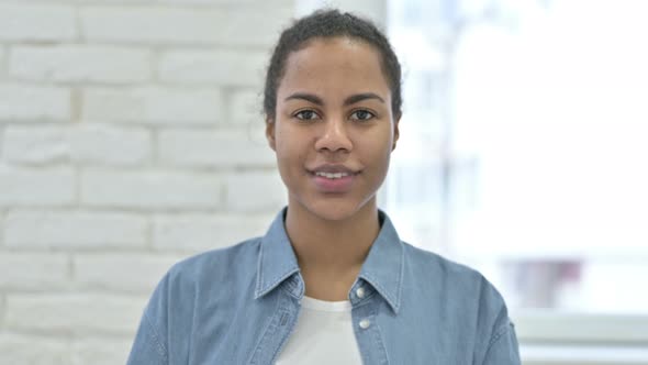 Young African Woman Smiling at Camera