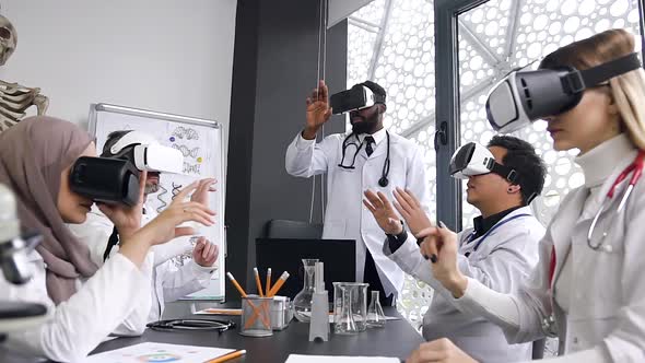 Doctors Team which Wearing Augmented Reality Glasses Working in the Hospital Indoor Cabinet