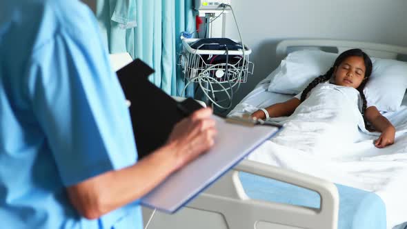 Female doctor writing on clipboard