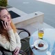Girl Sit in a Cafe on the Street Talking on the Phone - VideoHive Item for Sale