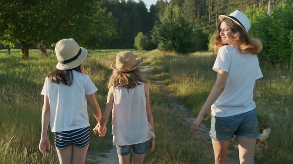 Children Three Girls in Hats Holding Hands Walking Back Along Rural Country Road