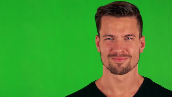 Young Handsome Caucasian Man Smiles To Camera - Green Screen - Studio - Closeup