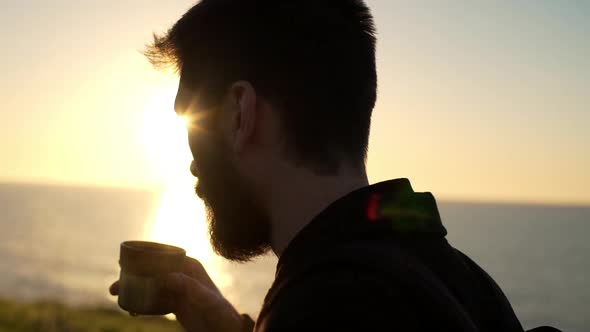 Bearded Man Blows on Tea Cup Horizon Sea Slow Motion