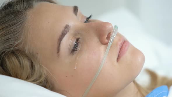 Depressed Female Patient With Nasal Cannula Looking Camera, Sickness Disability