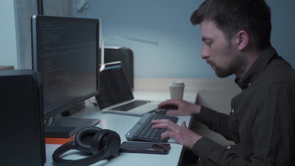 Young Caucasian Male Freelance As Computer Software Developer Writing Program Code From Home During