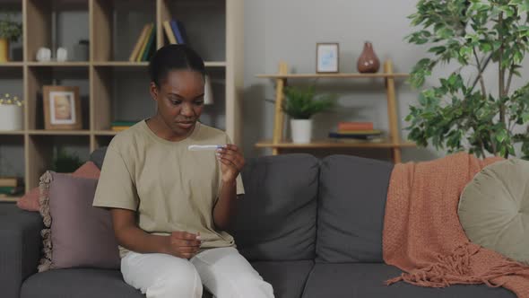 Depressed Woman Looking on Negative Pregnancy Test