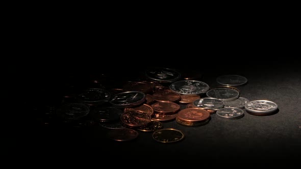 Coins on a Dark Surface. Spot Light