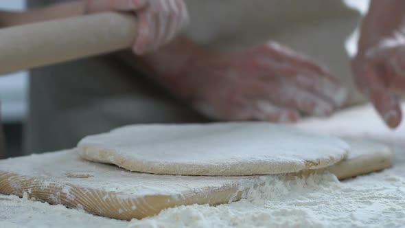 Little Daughter Carefully Rolling Dough, Helping Her Mother in Dinner Cooking