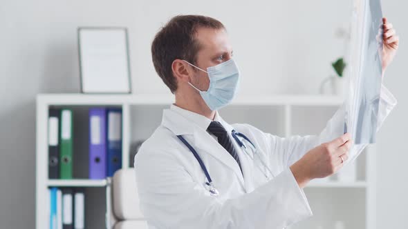 Professional medical doctor working in hospital office using computer technology.