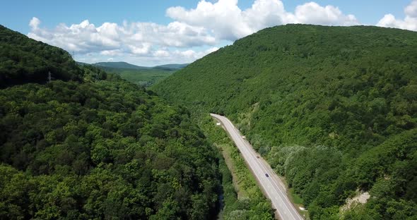 Aerial View of a Rural Highway Between Mountains