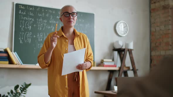 Female Teacher Speaking with Student on Lesson