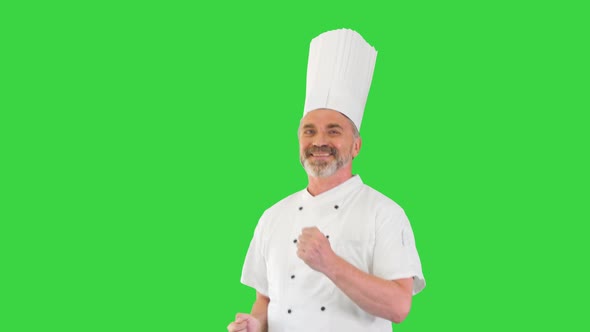 Mature Chef with Beard and in White Uniform Dancing on a Green Screen Chroma Key