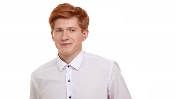 Shy Handsome Caucasian Foxy Young Man Standing on White Background Looking at Camera with