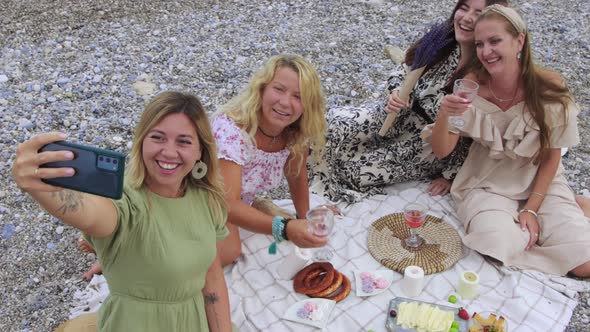 Four Happy Women Taking Selfie at the Picnic on the Beach