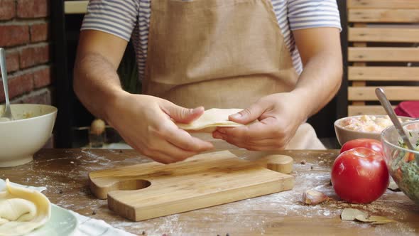 Man Cooking Empanada Argentinian Pie Traditional Bakery From Argentina Chef Filling Dough in Home